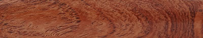 A turned strip of mesquite: warm orange-brown, evenly grained.