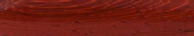 A turned strip of padauk: a strong, saturated red running the length of the grain.